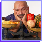 man struggling to choose between healthy food and junk food